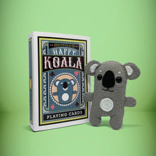 Load image into Gallery viewer, Mini grey koala felt toy that comes in its own bespoke matchbox. Complete with pillow and bedding - perfect for tucking in at night time. Your little friend also comes with an adoption certificate, collectible playing card, and thank you card.