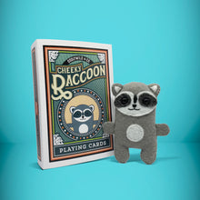 Load image into Gallery viewer, Mini grey raccoon felt toy that comes in its own bespoke matchbox. Complete with pillow and bedding - perfect for tucking in at night time. Your little friend also comes with an adoption certificate, collectible playing card, and thank you card.