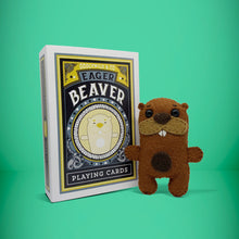 Load image into Gallery viewer, Mini brown beaver felt toy that comes in its own bespoke matchbox. Complete with pillow and bedding - perfect for tucking in at night time. Your little friend also comes with an adoption certificate, collectible playing card, and thank you card.