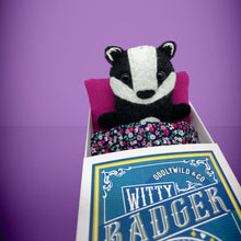 Load image into Gallery viewer, Handmade from felt this mini black and white badger toy stands 110mm high and is perfect for your kids to that with them on their travels and adventures. Your little friend is small enough to fit in a pocket and comes with its own matchbox and bedding. 