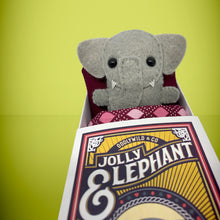 Load image into Gallery viewer, Handmade from felt this mini grey elephant toy stands 110mm high and is perfect for your kids to that with them on their travels and adventures. Your little friend is small enough to fit in a pocket and comes with its own matchbox and bedding. 