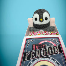 Load image into Gallery viewer, Mini Grey Penguin felt toy that comes in its own bespoke matchbox. Complete with pillow and bedding - perfect for tucking in at night time. Your little friend also comes with an adoption certificate, collectible playing card, and thank you card.