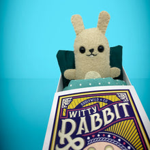 Load image into Gallery viewer, Handmade from felt this mini bunny rabbit toy stands 110mm high and is perfect for your kids to that with them on their travels and adventures. Your little friend is small enough to fit in a pocket and comes with its own matchbox and bedding.