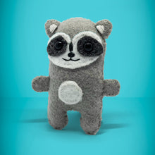 Load image into Gallery viewer, Front view of mini raccoon toy. A perfect little gift for any raccoon lover. Super cute, handmade from left over felt and a great keepsake present. Your little friend loves to cuddle, give hugs and comes with their own matchbox to sleep in. A wonderful stocking filler at christmas.