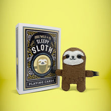 Load image into Gallery viewer, Mini brown sloth felt toy that comes in its own bespoke matchbox. Complete with pillow and bedding - perfect for tucking in at night time. Your little friend also comes with an adoption certificate, collectible playing card, and thank you card.